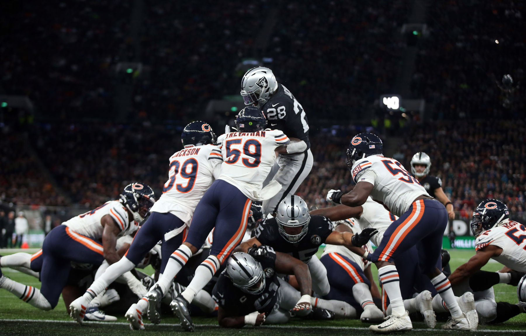 Oakland Raiders running back Josh Jacobs (28) dives over the line into the end zone for the game-winning touchdown against the Chicago Bears defense in the fourth quarter Sunday, Oct. 6, 2019 at Tottenham Hotspur Stadium in London, UK. The Raiders defeated the Bears, 24-21.